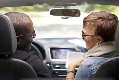 Rear view of couple traveling in car