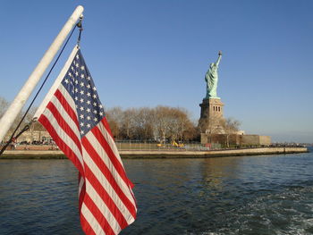 Statue of flags against clear sky