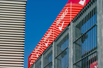 Low angle view of modern building against clear blue sky