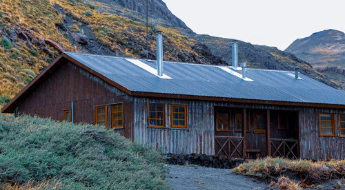 Exterior of old house on field against clear sky