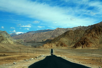  road by mountains against sky