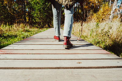 Low section of person standing on footpath