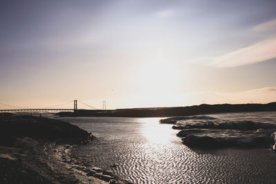 View of suspension bridge over sea