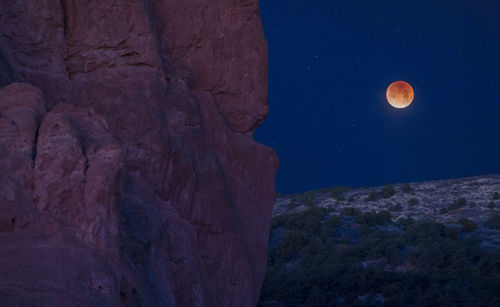 Low angle view of moon against clear sky at night