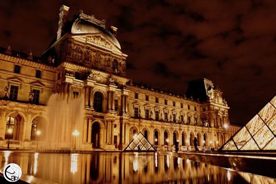 Low angle view of illuminated building at night
