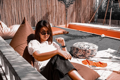 Portrait of smiling woman sitting outdoors