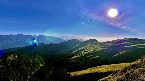 Scenic view of mountains against blue sky