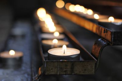 Lit tea light candles in temple