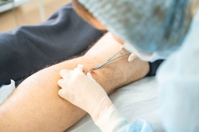 Midsection of doctor examining patient