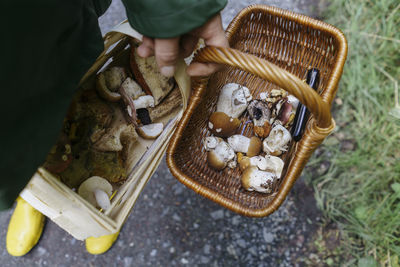 Man holding baskets of mushrooms