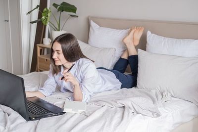 Young woman using laptop at home