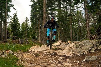 Man riding bicycle in forest