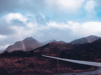 View of mountain road against cloudy sky