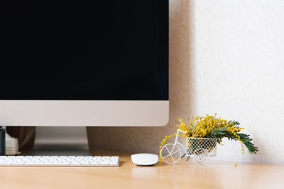 Concept of a business, freelancer, blogger. the laptop is on a wooden table against a white wall