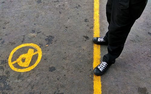 Man standing on road marking