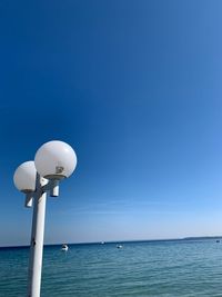 Scenic view of sea against clear blue sky