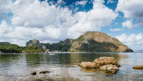 Scenic view of lake and rocks against sky