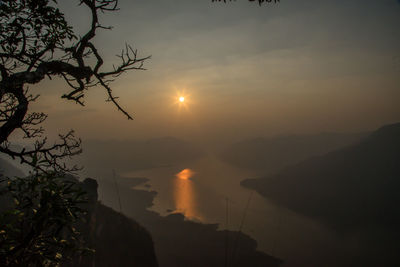 Scenic view of silhouette mountains against sky at sunset