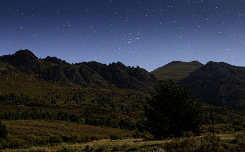 Scenic view of mountains against sky at night