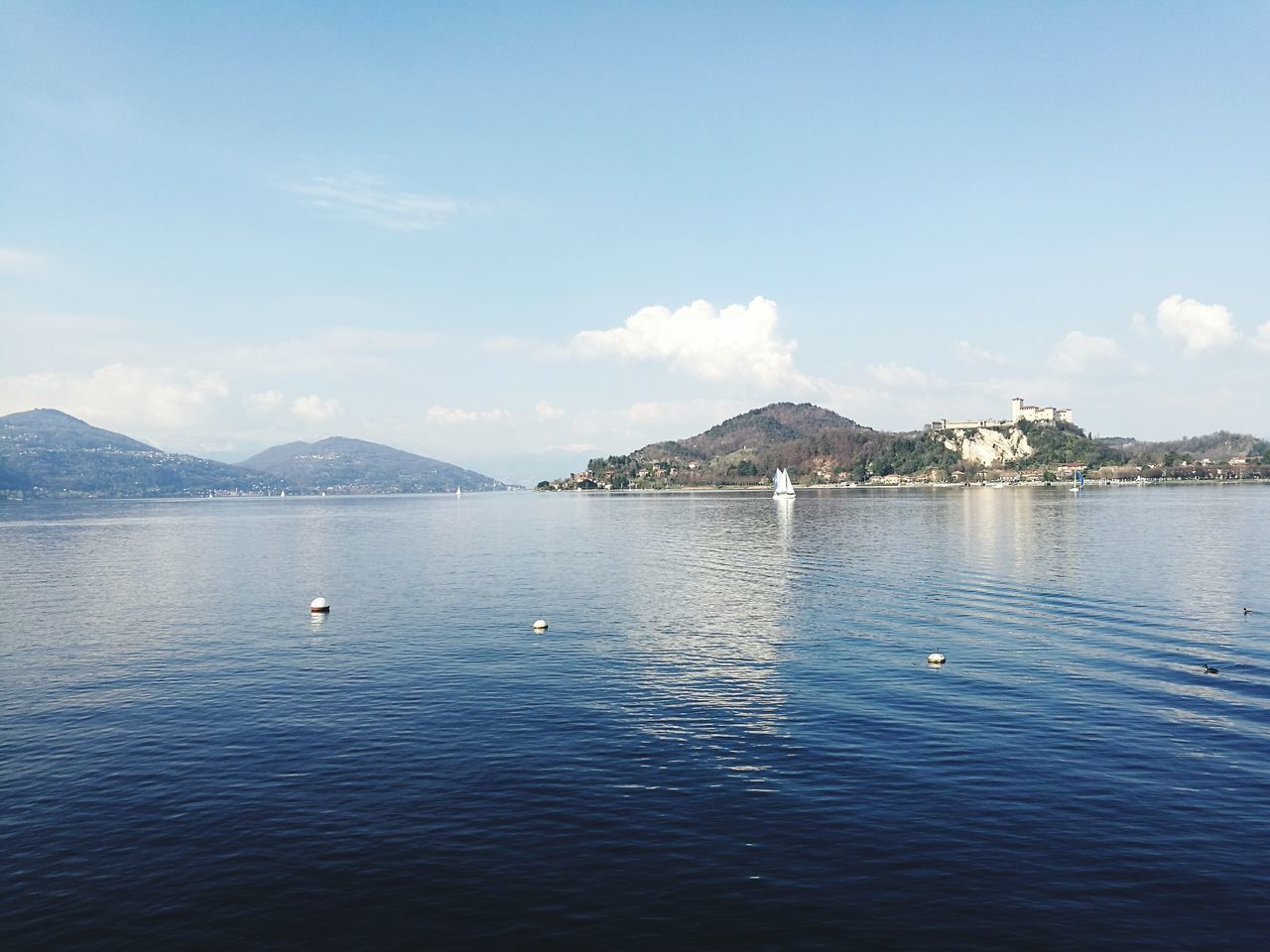 water, mountain, scenics, sea, beauty in nature, nature, rippled, idyllic, no people, waterfront, outdoors, tranquil scene, day, sky