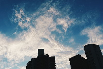 Low angle view of building against cloudy sky