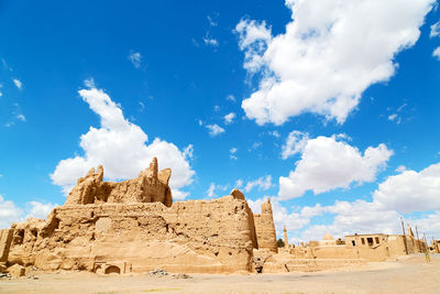 Panoramic view of desert against cloudy sky