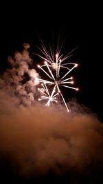 Low angle view of firework display at night