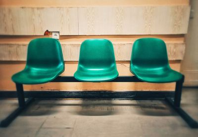 Empty chairs against tiled floor