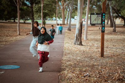 Rear view of woman walking on street