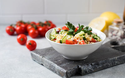 Eastern bulgur and vegetable tabbouleh salad in a plate. vegetarian dish.