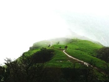 Scenic view of landscape against cloudy sky