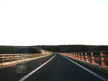 Empty road along trees