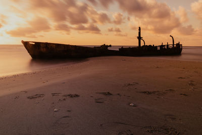 Scenic view of beach against sky during sunset