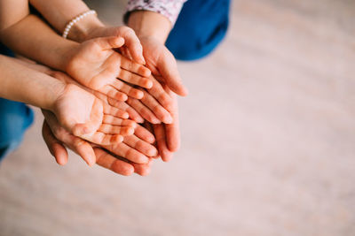 Midsection of couple hands on beach