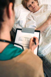 Close-up of woman using mobile phone at home