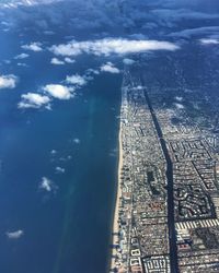 High angle view of buildings by sea against sky