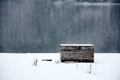 White house on snow covered field against building