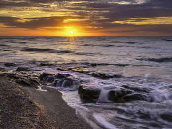 Scenic view of sea against sky during sunset