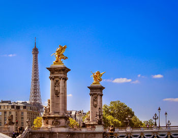 Low angle view of statue against blue sky