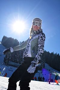 Woman wearing warm clothing standing in snow