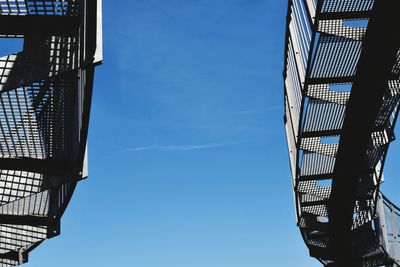 Low angle view of bridge against blue sky