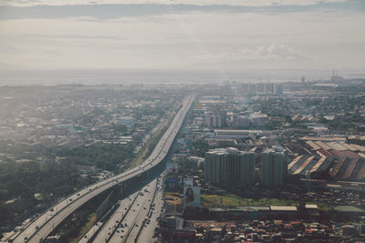 Aerial view of cityscape against sky on sunny day