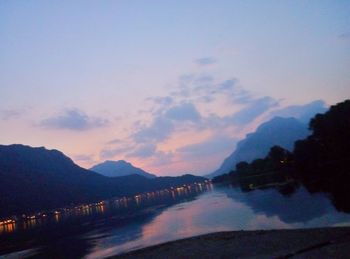 Scenic view of lake against sky at sunset