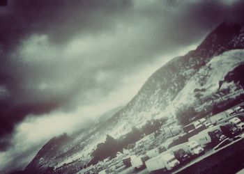Scenic view of mountains against cloudy sky