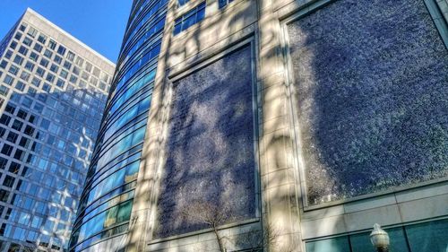 Low angle view of modern building against blue sky