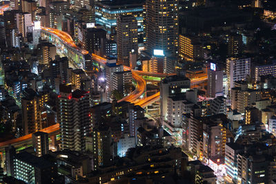 High angle view of city lit up at night