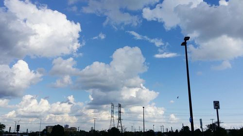 Low angle view of silhouette street light against sky