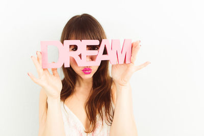 Close-up of woman with hand on white background