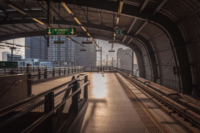 View of railroad station platform during sunset