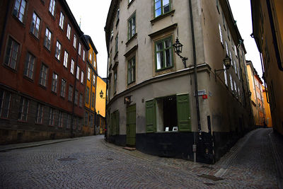 Empty alley amidst buildings in city